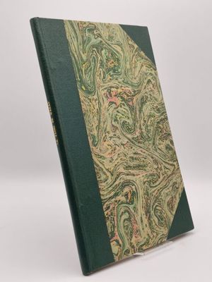 un livre à la couverture verte, orné d'un motif paisley
