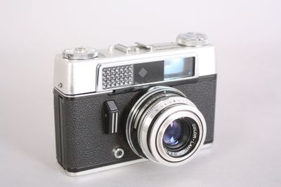 a black and white photo of a camera on a table