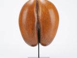 a close up of a sculpture of a coffee bean on a metal stand