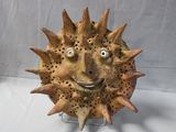 a sculpture of a sunflower with a face made out of it