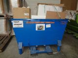 a blue dumpster sitting in the middle of a warehouse