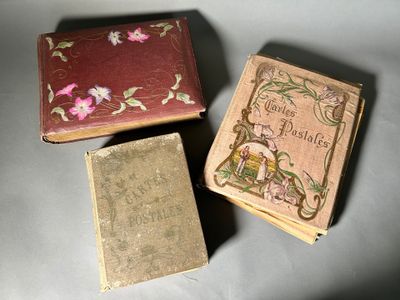 three old books sitting on top of a table next to each other