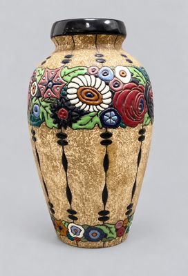 a vase with flowers painted on it sitting on a table