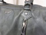 a close up of a black purse with a zipper