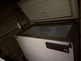 a white chest freezer sitting inside of a garage