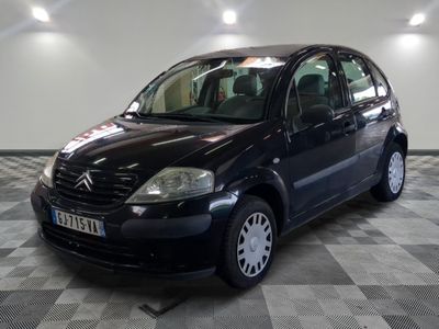 a picture of a small black car parked in a garage