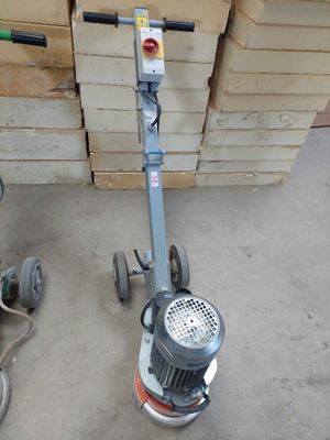 a machine that is sitting on the floor next to a pile of boxes