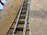 a ladder that is laying on the ground in a garage