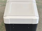 a black and white cooler sitting on the floor