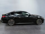 the bmw z4 is parked in a garage with a gray floor