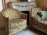 two chairs that are sitting in front of a fireplace
