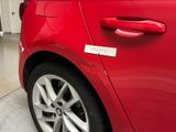 a red car with a sticker on the side of it