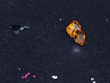 a close up of a yellow diamond on a black surface