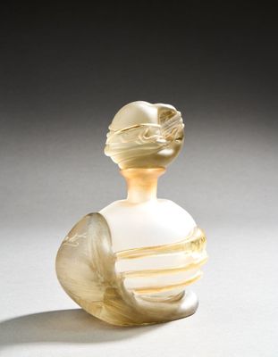 a glass vase with a white and yellow design on it