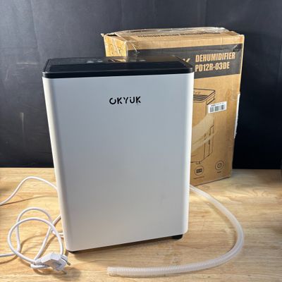 an image of a white refrigerator sitting on top of a wooden table
