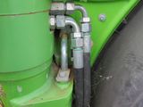 a green machine that is sitting on the ground