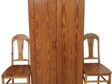 two chairs that are next to a tall wooden cabinet