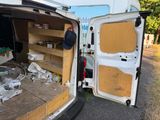 a van that has been vandalized and is parked on the side of the road