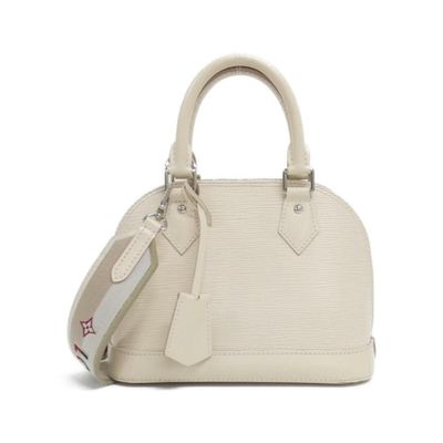 the small white bag is sitting on a white surface