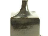 a black bottle with a gold cap on a white background