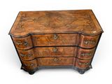 an antique chest of drawers with a carved top and drawers