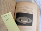 an open book with a yellow sticker on top of it
