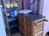 a wooden cabinet in the corner of a room