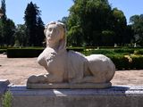 a statue of a lion that is sitting on a ledge