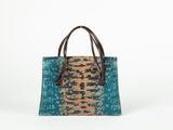 the small tote bag is made from recycled materials and has a leather handle