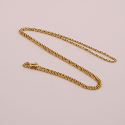 a gold necklace with a chain on a white background