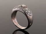 a close up of a diamond ring on a reflective surface