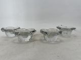 three clear glass vases sitting on top of a white surface