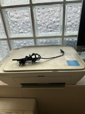 an image of a printer sitting on a window sill