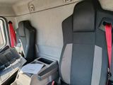 two seats in the back of a van with a cup holder