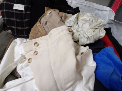 a pile of clothes that is sitting in a suitcase