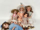 a lot of dolls that are laying on the ground