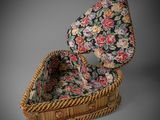an antique wicker basket with a floral print lining and a wooden handle