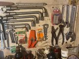 many tools hanging on the wall in the garage
