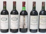 several bottles of wine are lined up in a row