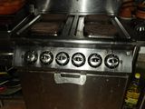 a lot of donuts on the stove in the kitchen