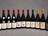 several bottles of wine are lined up in a row on a table