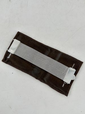 a piece of cloth with a piece of tape attached to it