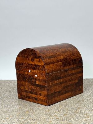 an old wooden box sitting on top of a floor next to a white wall