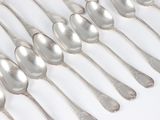 a lot of spoons that are sitting on a table