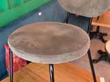 two chairs and a table in a room with a green wall