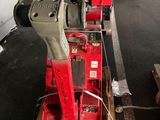 a red machine that is sitting on a pallet