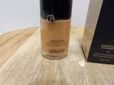 the bottle of liquid foundation is sitting on a table next to a box