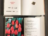 an open book with a picture of red tulips on it