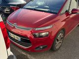 a red car that is parked in a parking lot