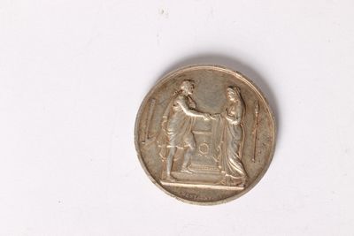 an image of a coin with a statue on it on a white surface